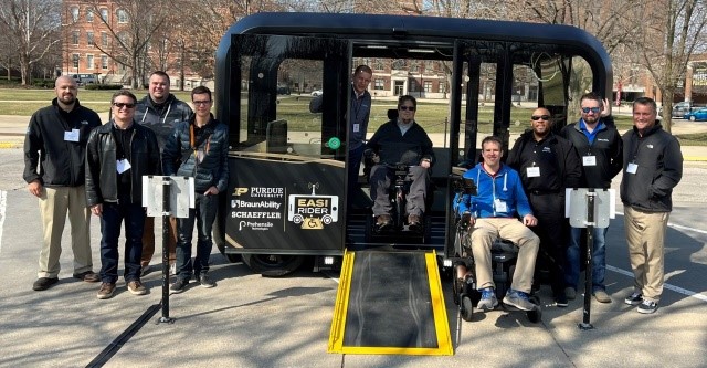 Group of people standing by Inclusive Design Challenge winner: Purdue University EASI RIDER. 